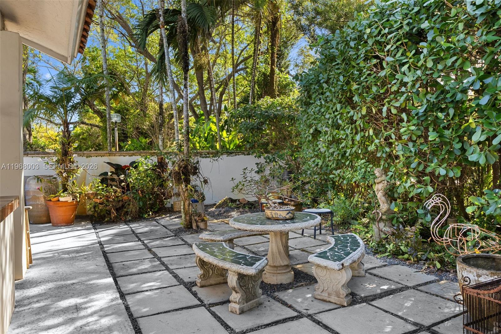 11220 Southwest 67th Avenue Pinecrest, FL 33156 - Photo 21 of 42 a view of a patio with table and chairs and potted plants