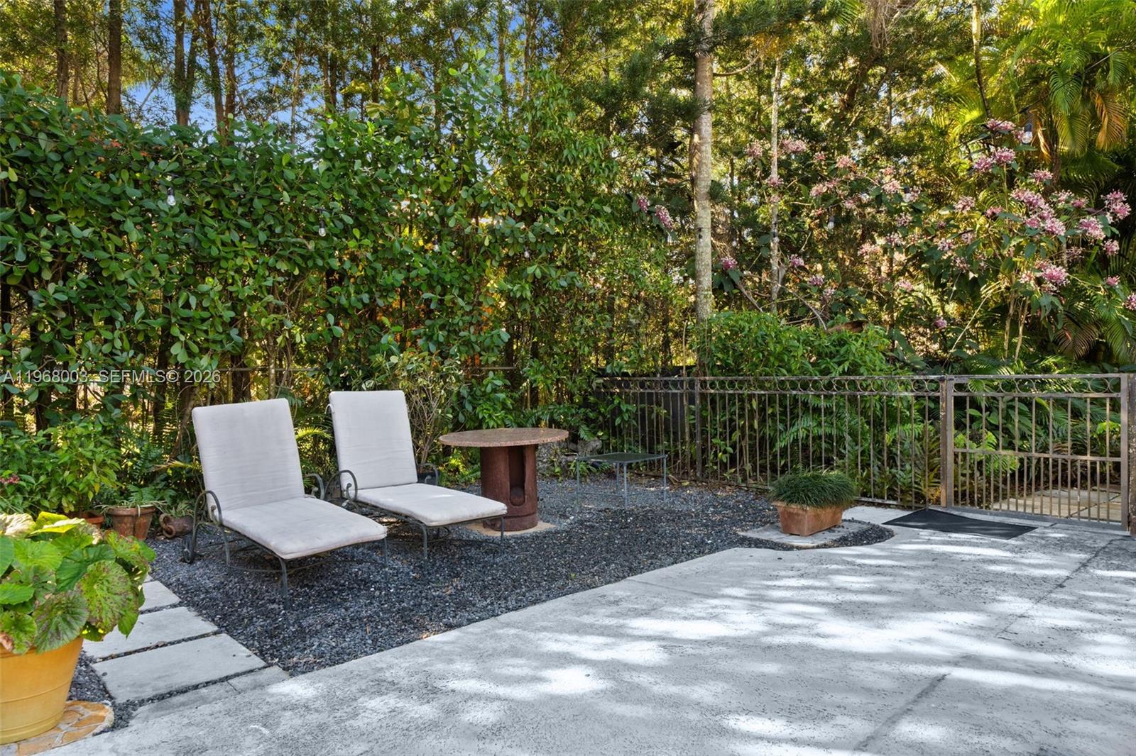 11220 Southwest 67th Avenue Pinecrest, FL 33156 - Photo 22 of 42 a view of a chair and table in the garden