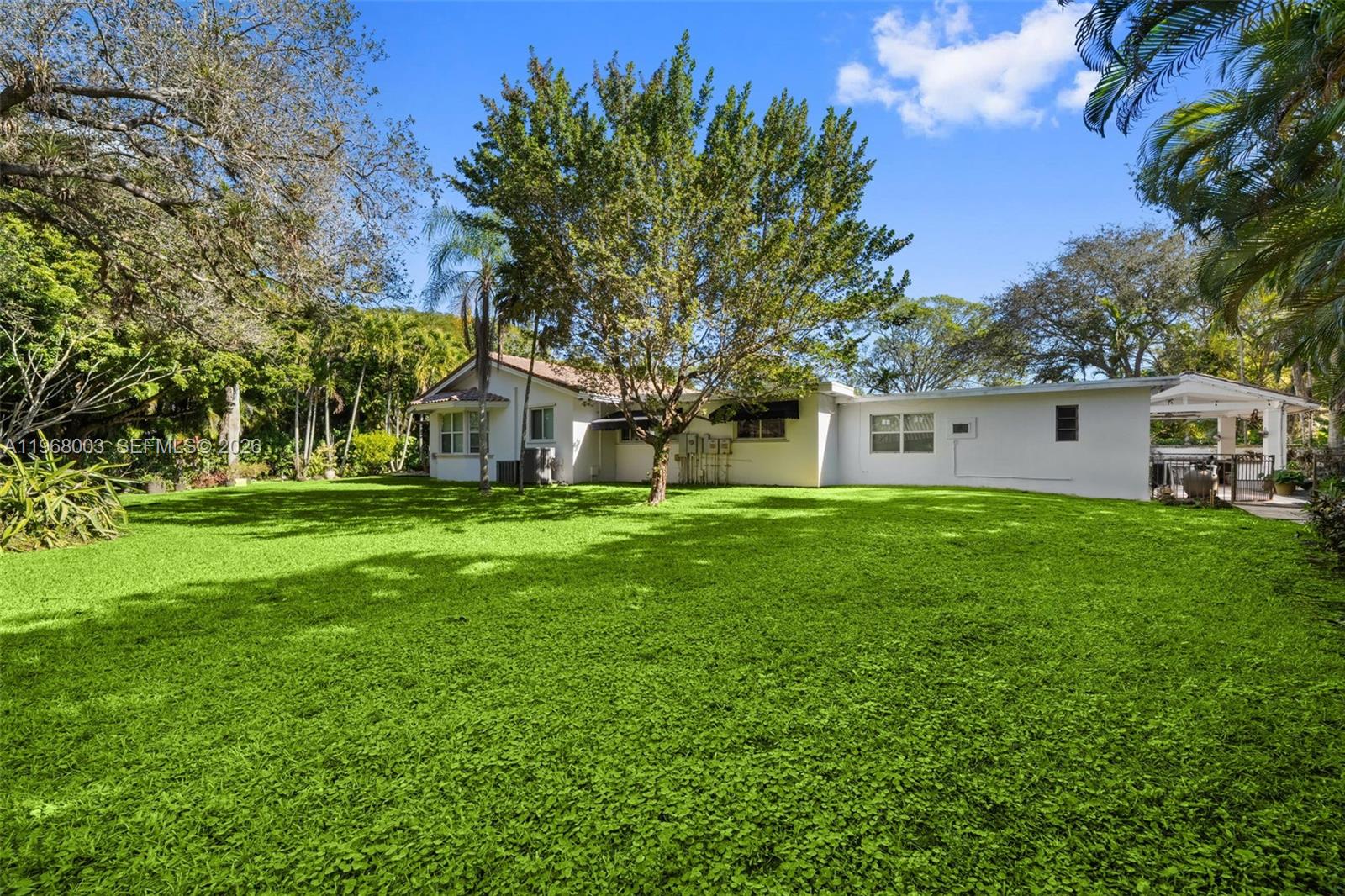 11220 Southwest 67th Avenue Pinecrest, FL 33156 - Photo 23 of 42 a house view with a garden space