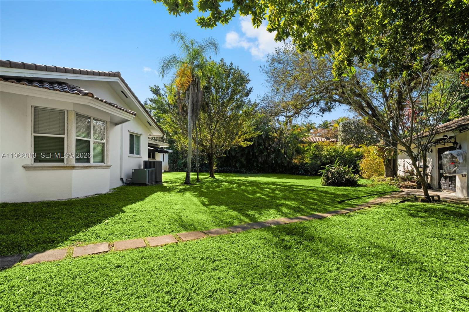 11220 Southwest 67th Avenue Pinecrest, FL 33156 - Photo 28 of 42 a view of a house with a backyard