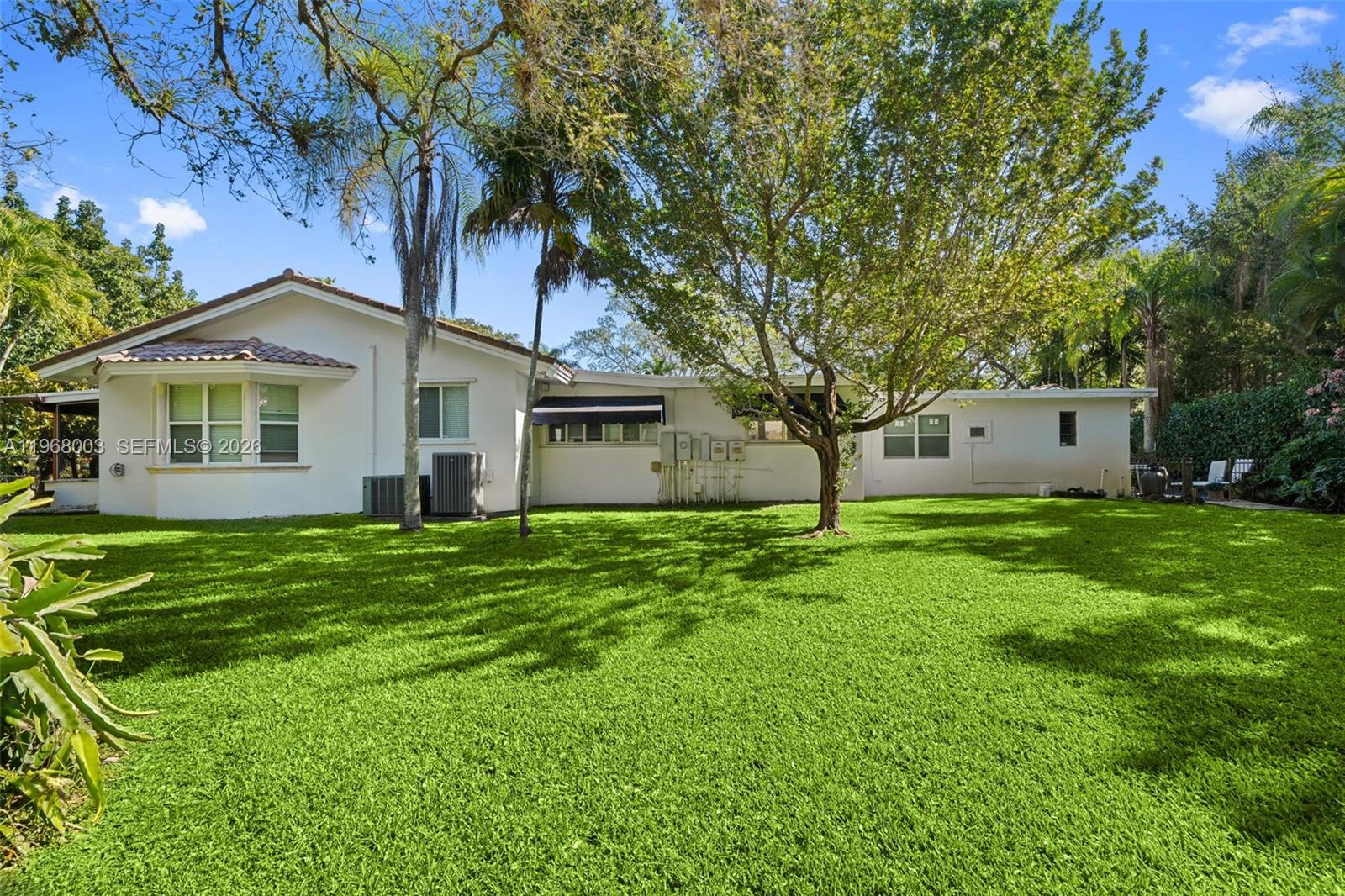 11220 Southwest 67th Avenue Pinecrest, FL 33156 - Photo 29 of 42 a front view of house with a garden