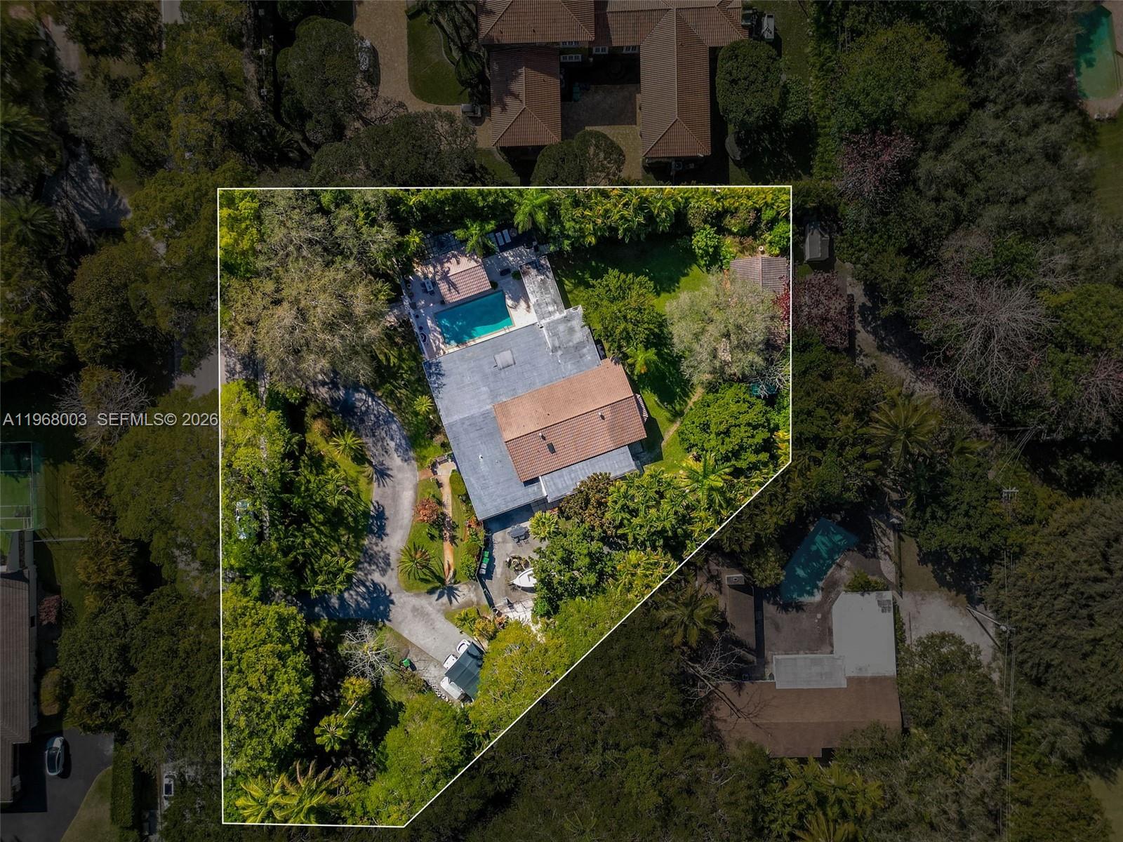 11220 Southwest 67th Avenue Pinecrest, FL 33156 - Photo 3 of 42 an aerial view of a house with a yard