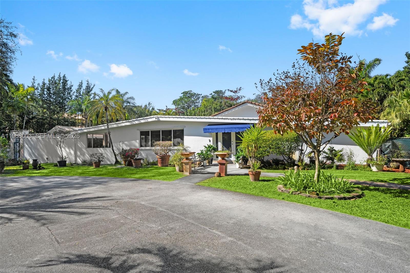 11220 Southwest 67th Avenue Pinecrest, FL 33156 - Photo 41 of 42 a view of a house with a yard and sitting area