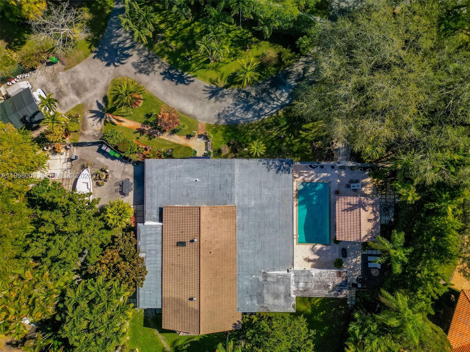 11220 Southwest 67th Avenue Pinecrest, FL 33156 - Photo 6 of 42 an aerial view of a house with a yard and large tree