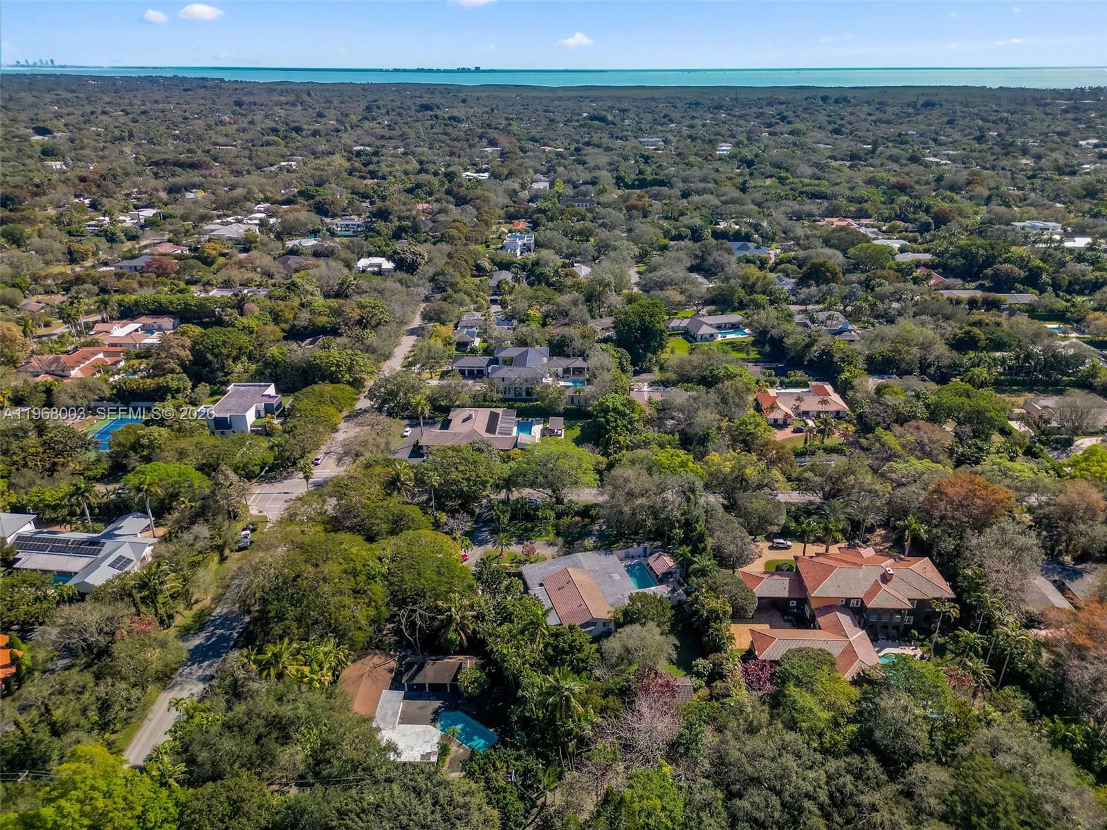 11220 Southwest 67th Avenue Pinecrest, FL 33156 - Photo 9 of 42 an aerial view of a town with trees