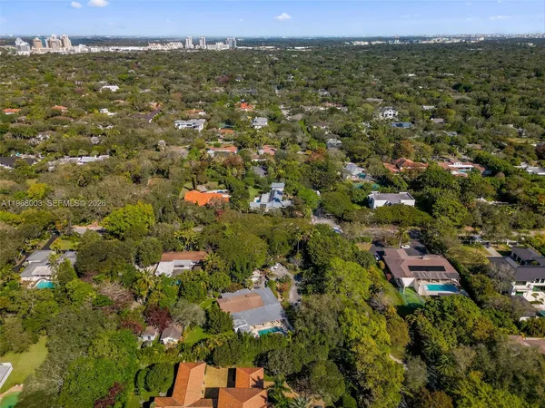 an aerial view of residential houses with city view