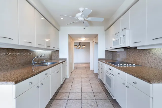 a view of washer and dryer with kitchen in the background
