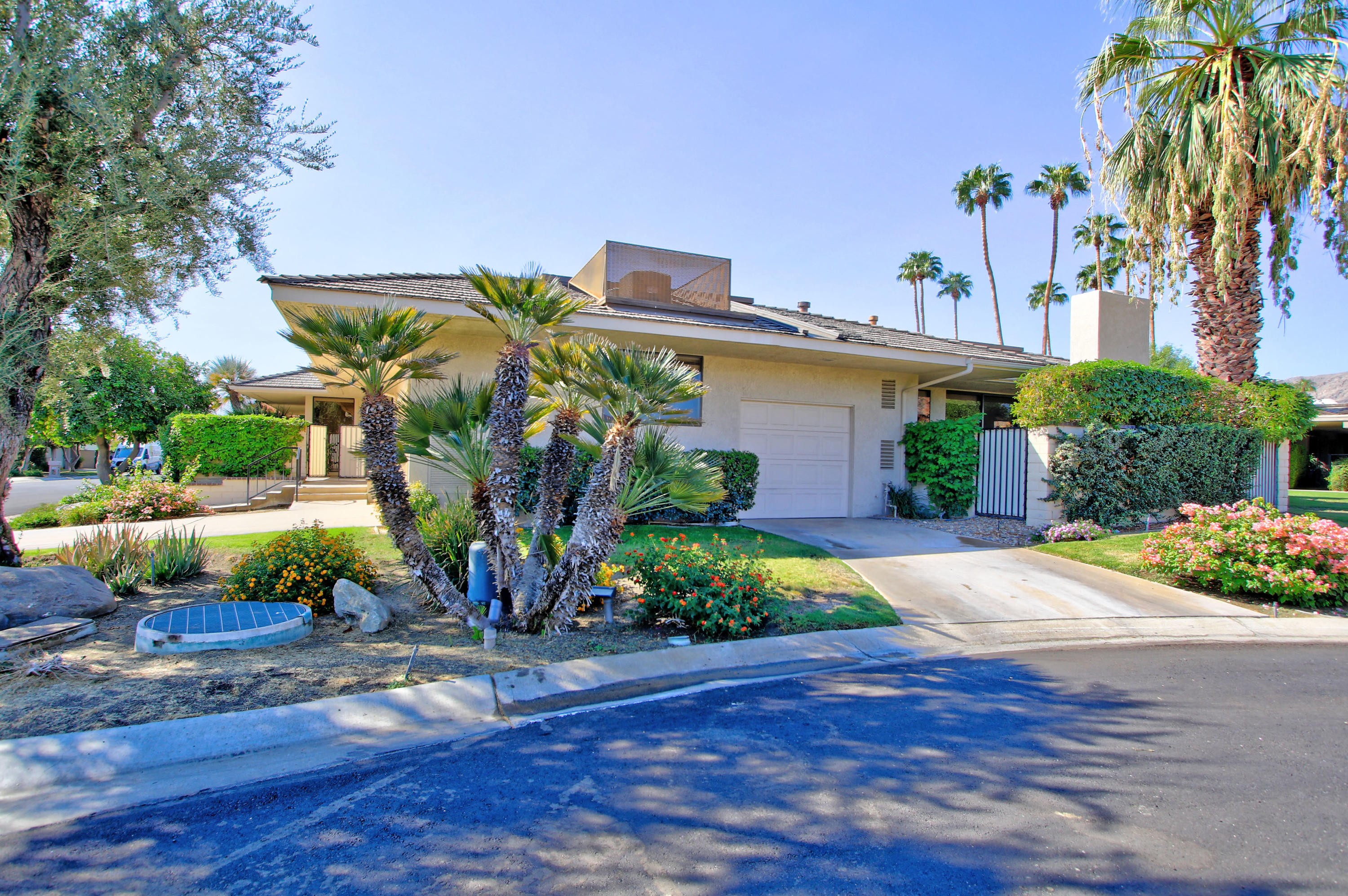 14 Colgate Drive Rancho Mirage, CA 92270 - Photo 2 of 46 a view of a house with a yard and potted plants