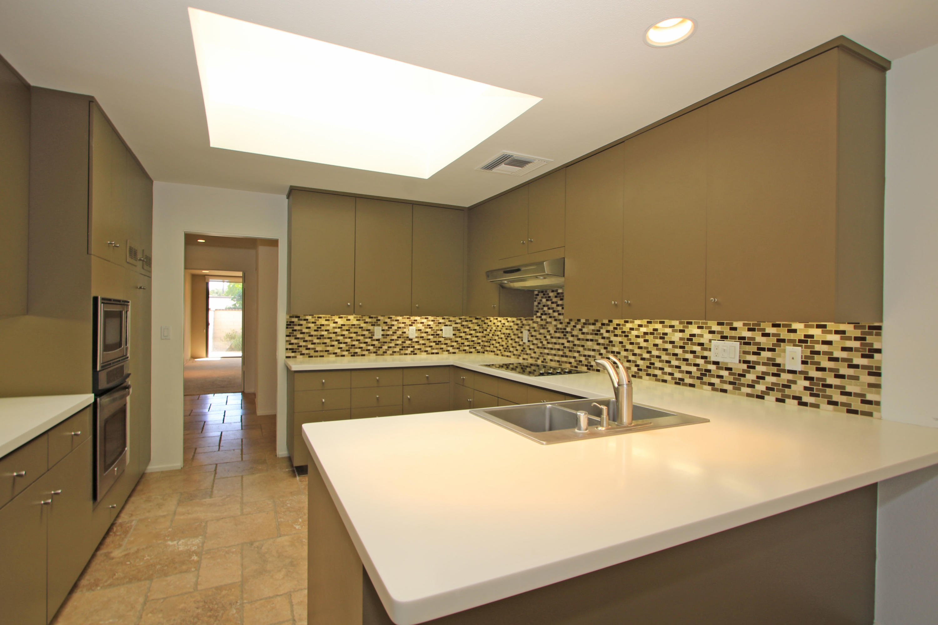 14 Colgate Drive Rancho Mirage, CA 92270 - Photo 13 of 46 a kitchen with a sink and a refrigerator