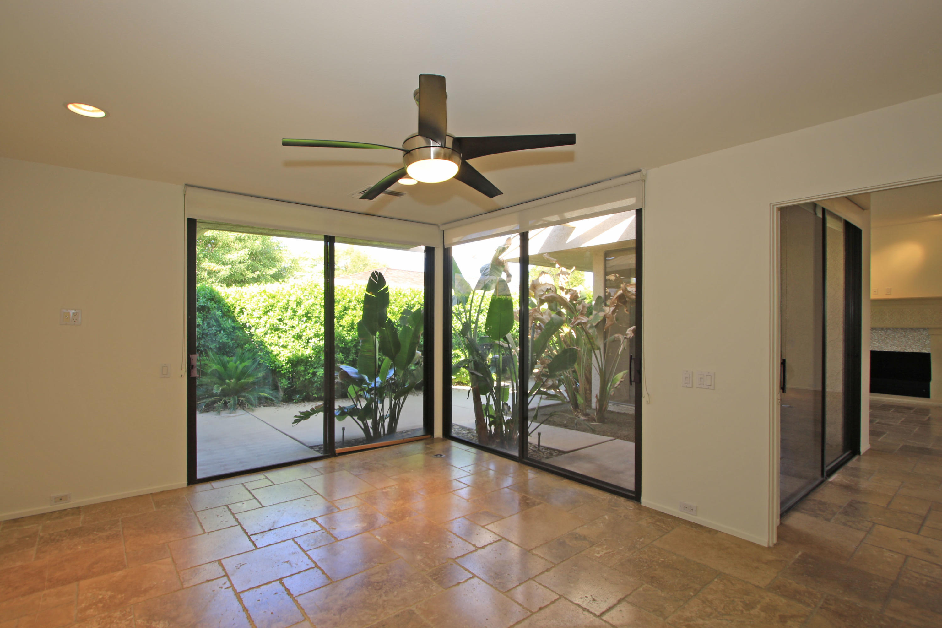 14 Colgate Drive Rancho Mirage, CA 92270 - Photo 17 of 46 a view of empty room with balcony and ceiling fan