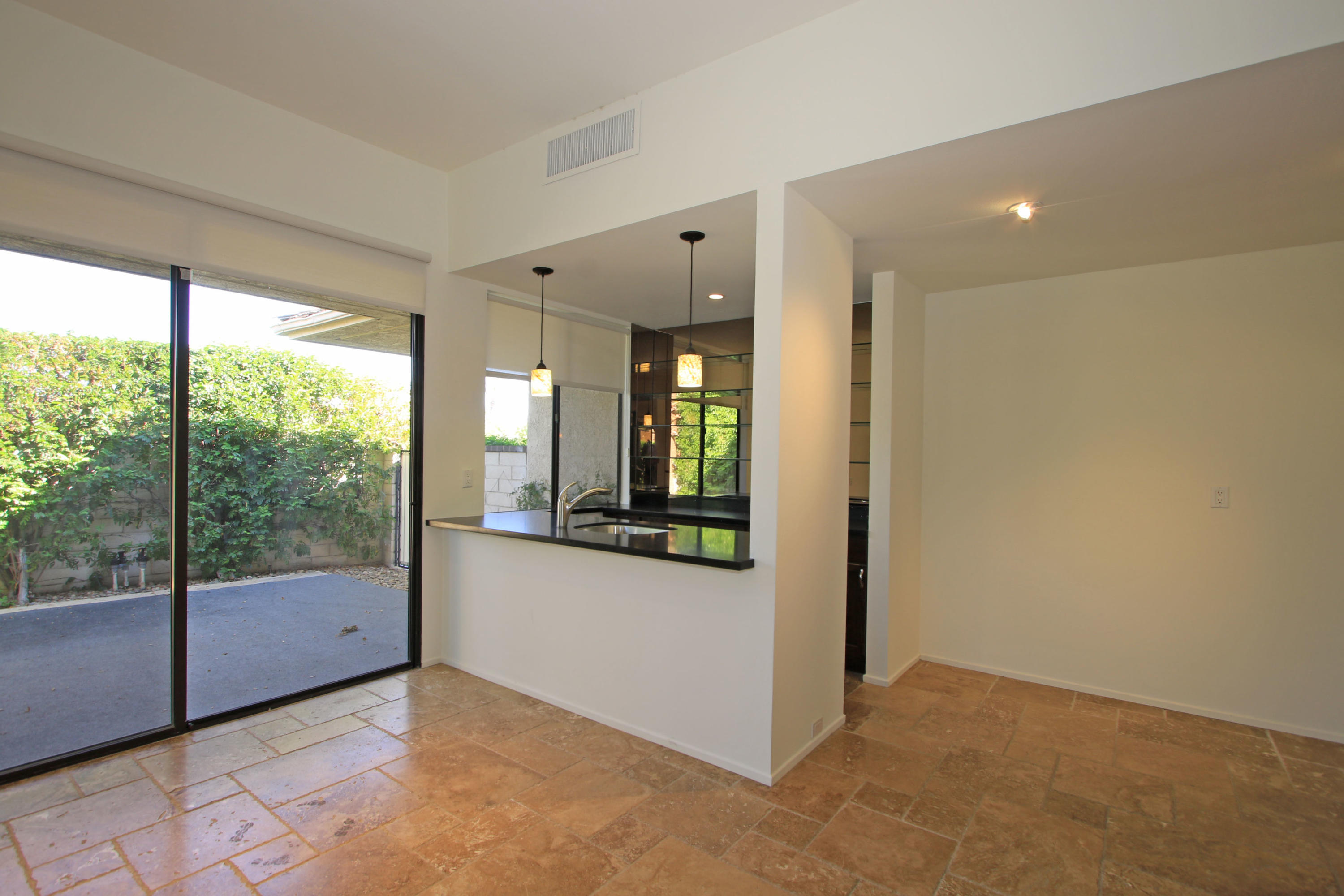 14 Colgate Drive Rancho Mirage, CA 92270 - Photo 22 of 46 a view of an empty room with wooden floor and a window