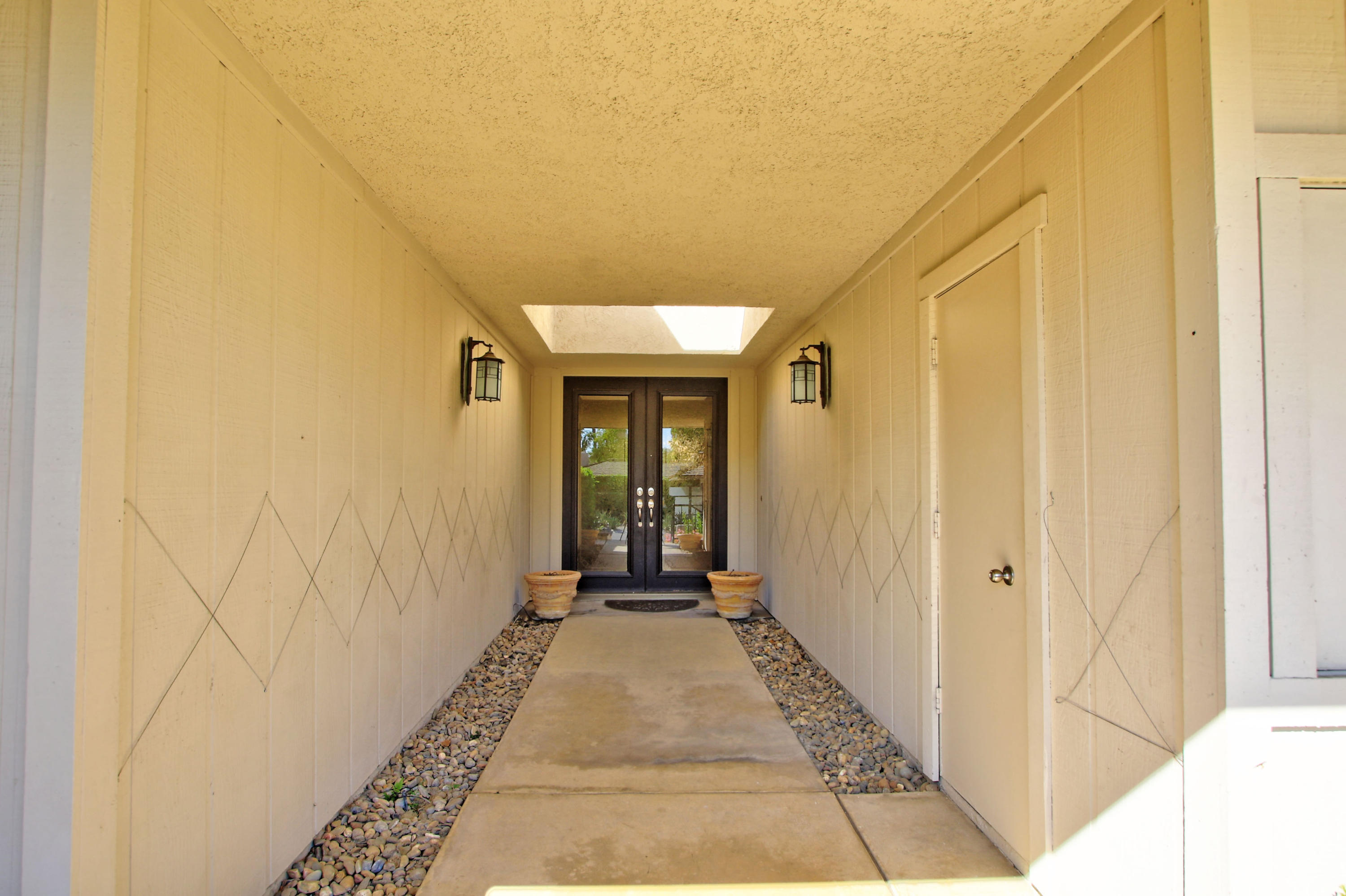 14 Colgate Drive Rancho Mirage, CA 92270 - Photo 4 of 46 a view of a hallway with wooden floor and a bathroom