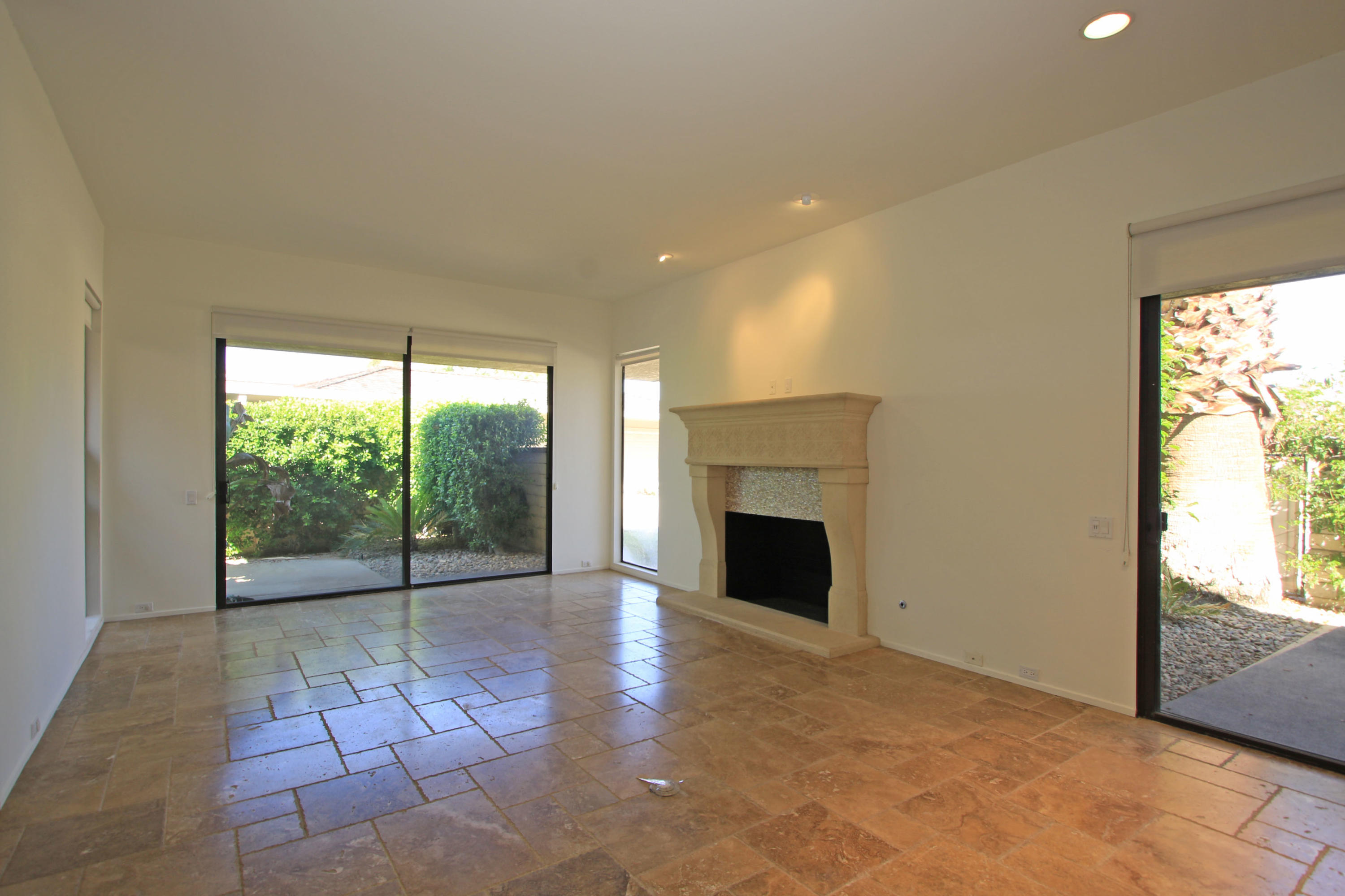 14 Colgate Drive Rancho Mirage, CA 92270 - Photo 7 of 46 a view of empty room with a fireplace and window
