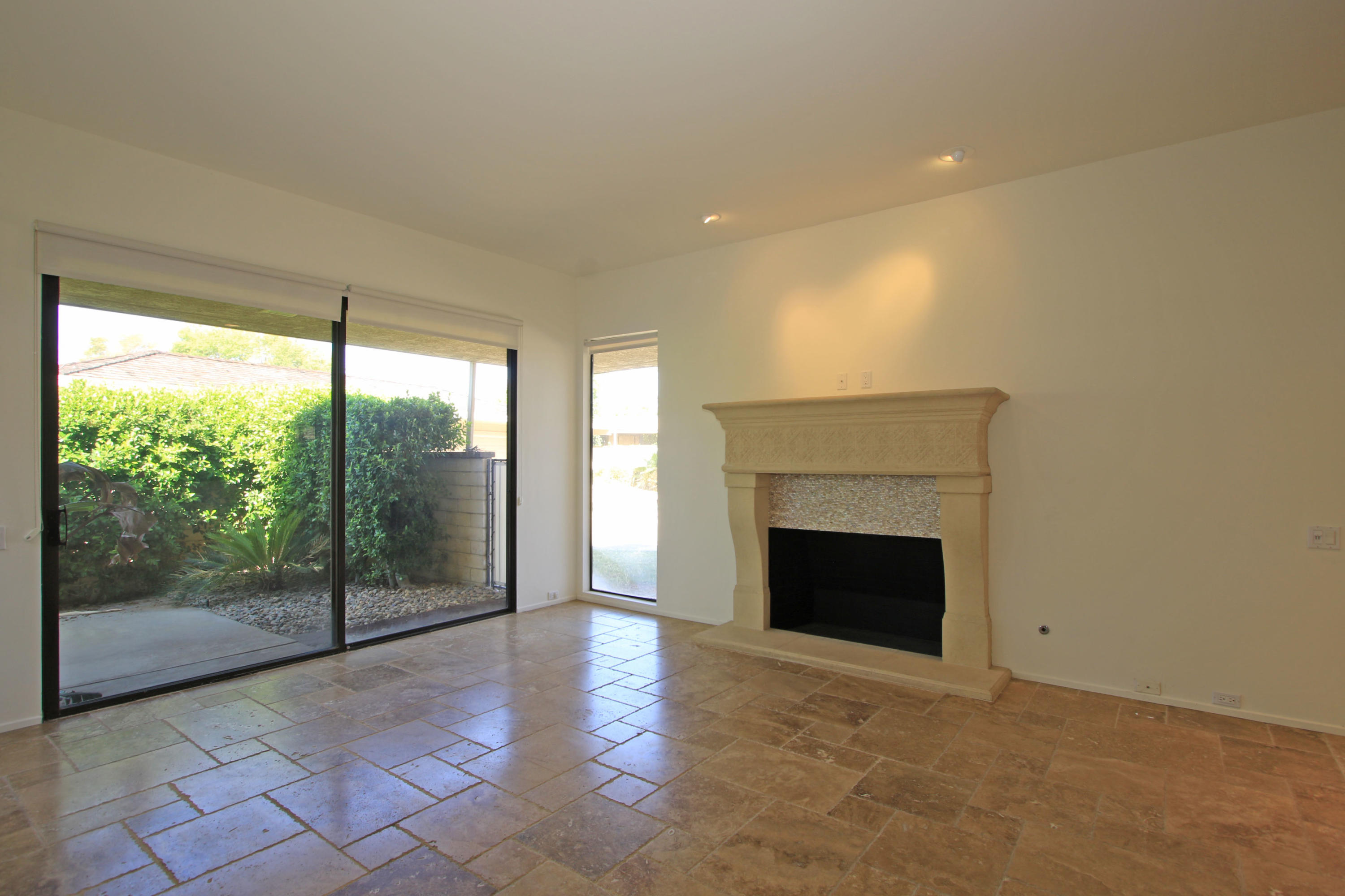 14 Colgate Drive Rancho Mirage, CA 92270 - Photo 8 of 46 a view of empty room with wooden floor and fireplace