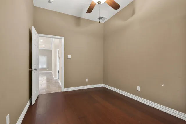 an empty room with wooden floor and closet