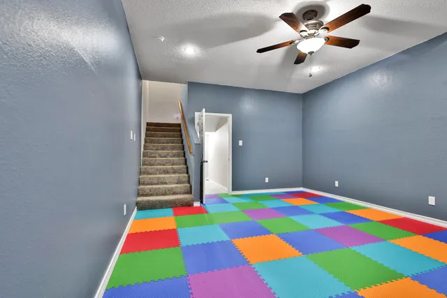 a room that has a rug and a white chair