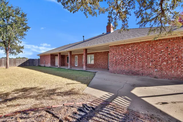 a backyard of a house with wooden fence