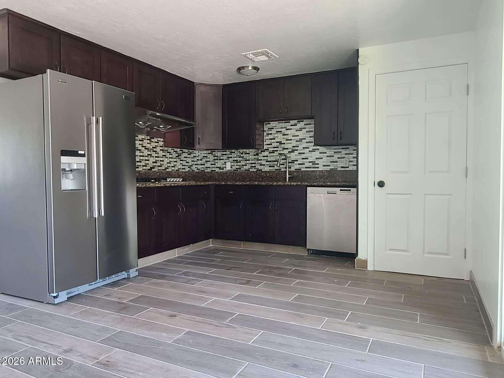 3702 East Thunderbird Road Phoenix, AZ 85032 - Photo 8 of 23 a kitchen with stainless steel appliances granite countertop a refrigerator and a sink