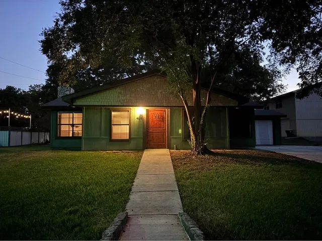 a front view of a house with yard