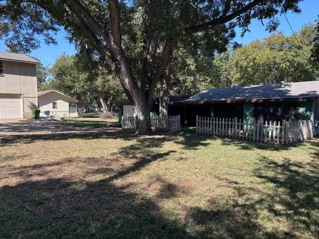 a view of a house with a yard covered in snow