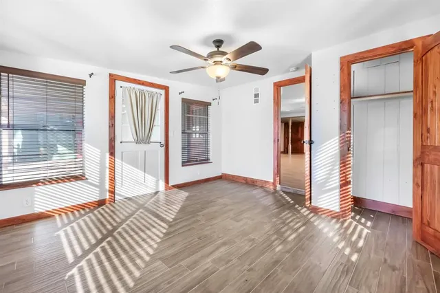 a view of an empty room with wooden floor