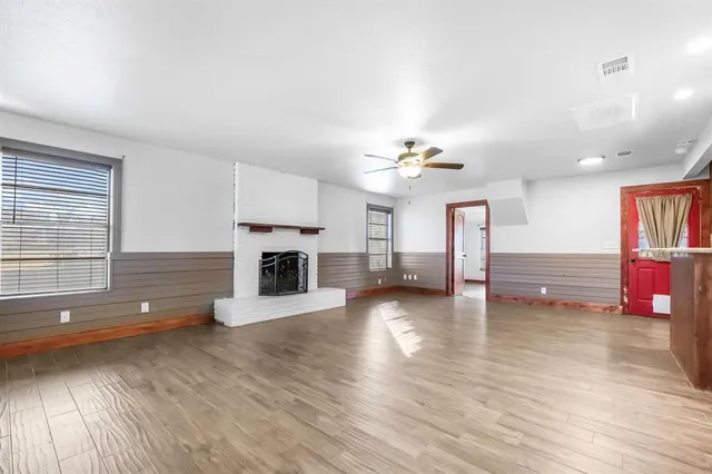 a view of a room wooden floor and fire place