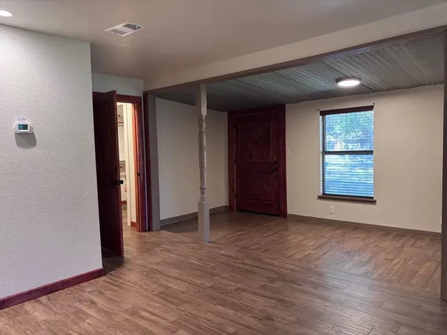 a backyard of a house with barbeque oven table and chairs