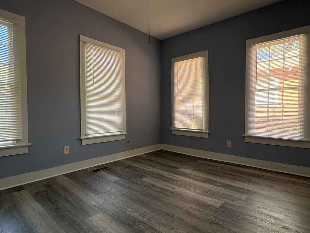 2427 Marion Street Columbus, GA 31906 - Photo 12 of 23 a view of an empty room with wooden floor and a window