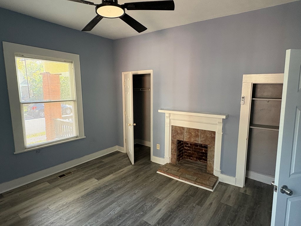 2427 Marion Street Columbus, GA 31906 - Photo 21 of 23 a view of an empty room with wooden floor fireplace and a window