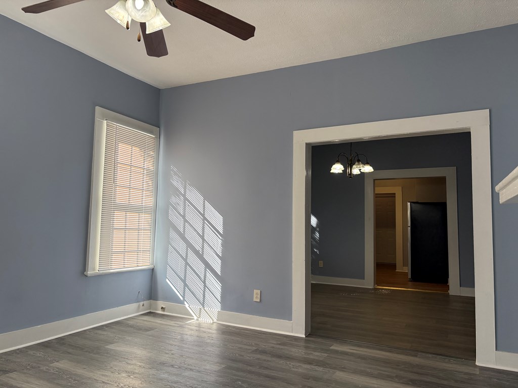 2427 Marion Street Columbus, GA 31906 - Photo 3 of 23 an empty room with wooden floor chandelier and windows
