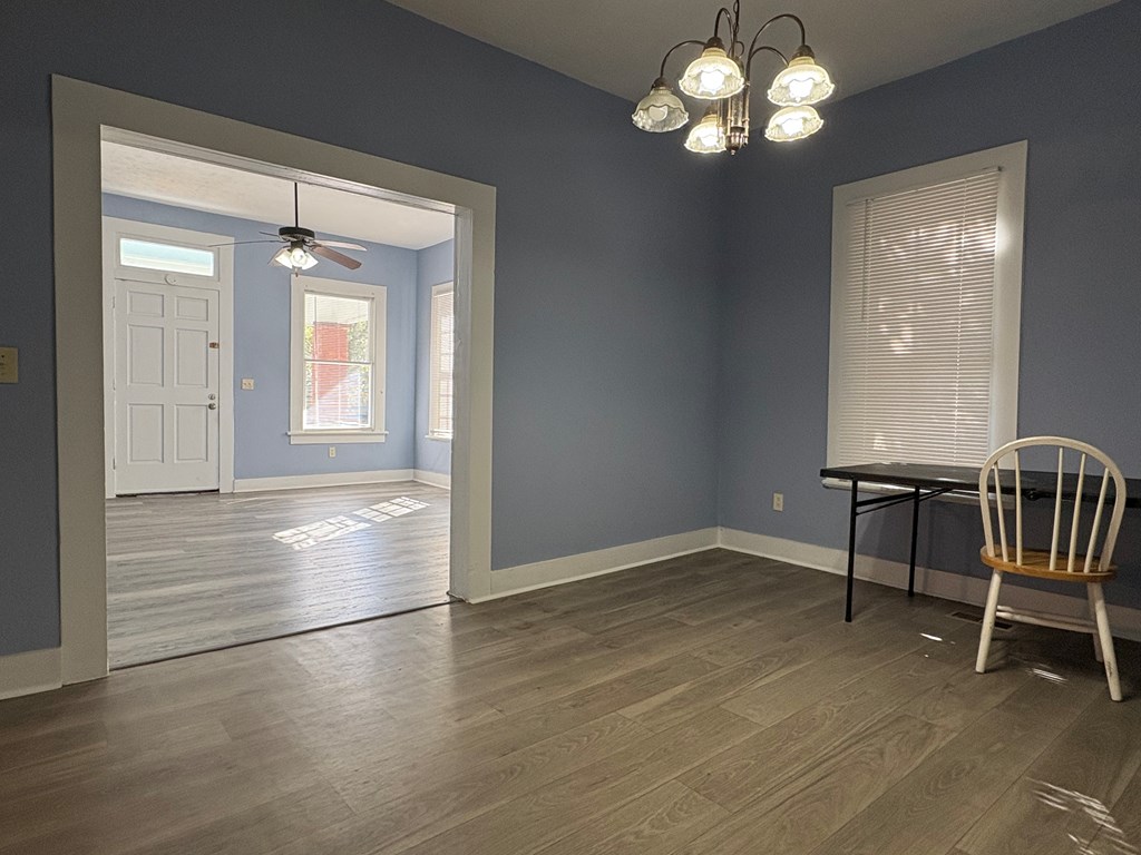 2427 Marion Street Columbus, GA 31906 - Photo 6 of 23 an empty room with wooden floor and windows
