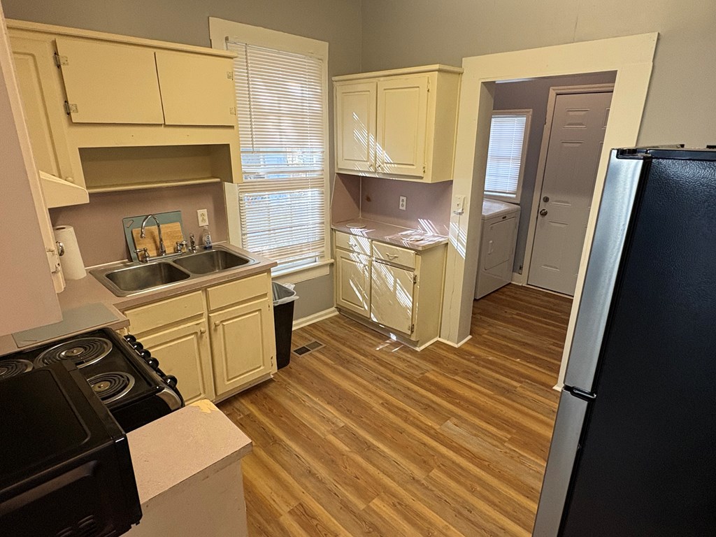 2427 Marion Street Columbus, GA 31906 - Photo 9 of 23 a kitchen with a sink stove and cabinets