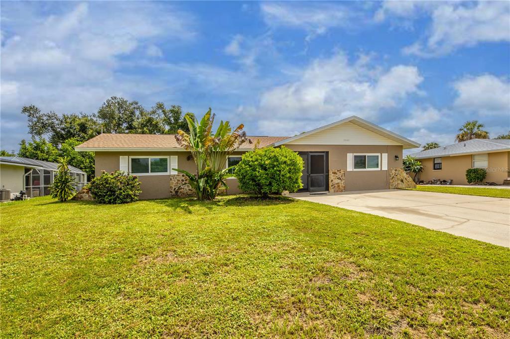 2084 Haskell Street Port Charlotte, FL 33952 - Photo 1 of 1 a front view of a house with a yard