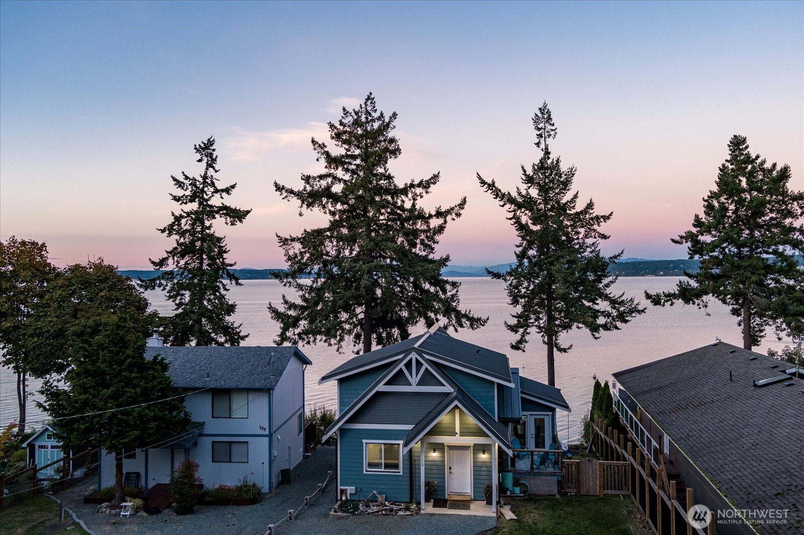 159 South Harrington Lagoon Road Coupeville, WA 98239 - Photo 1 of 37 a front view of a house with a yard and garage