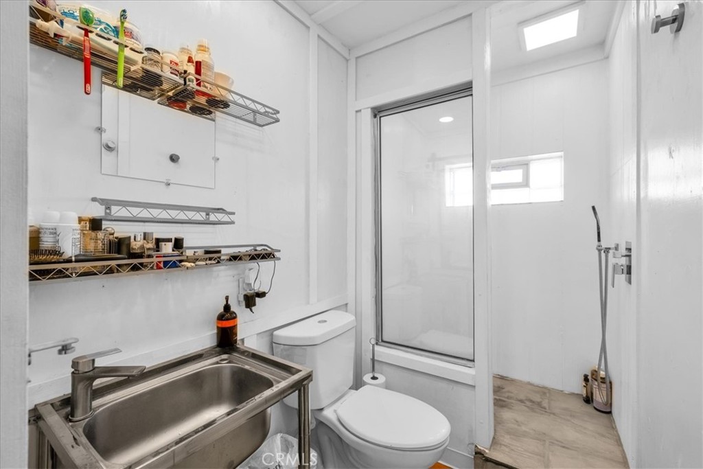 84951 Amboy Road Twentynine Palms, CA 92277 - Photo 14 of 36 a bathroom with a sink a toilet and shower