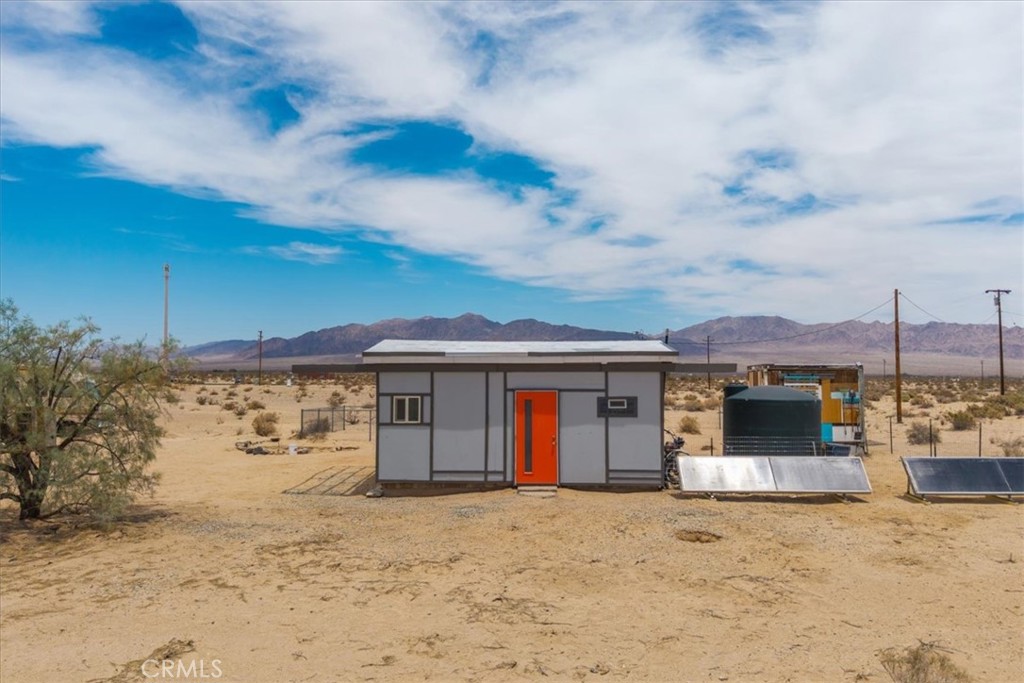84951 Amboy Road Twentynine Palms, CA 92277 - Photo 27 of 36 a front view of a house with a yard and garage