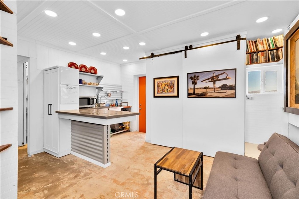 84951 Amboy Road Twentynine Palms, CA 92277 - Photo 5 of 36 a kitchen with kitchen island stainless steel appliances a stove refrigerator sink and cabinets