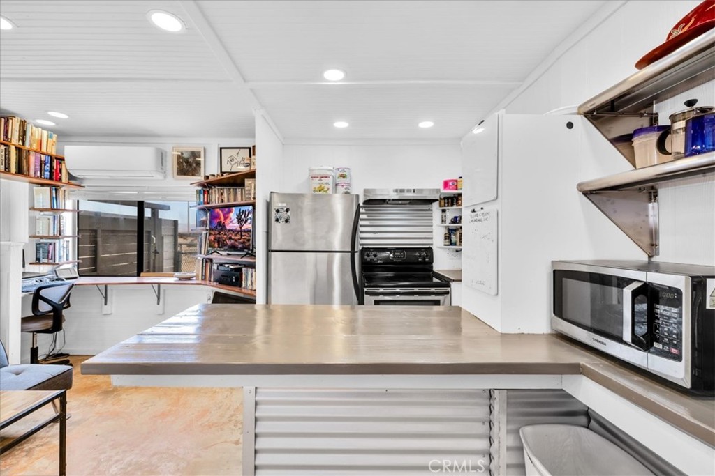 84951 Amboy Road Twentynine Palms, CA 92277 - Photo 10 of 36 a kitchen with stainless steel appliances granite countertop a sink and a refrigerator