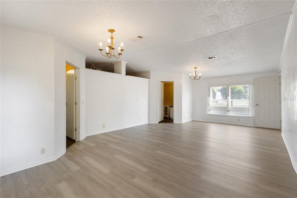 4912 Miley Road Plant City, FL 33565 - Photo 11 of 48 a view of an empty room with window and wooden floor
