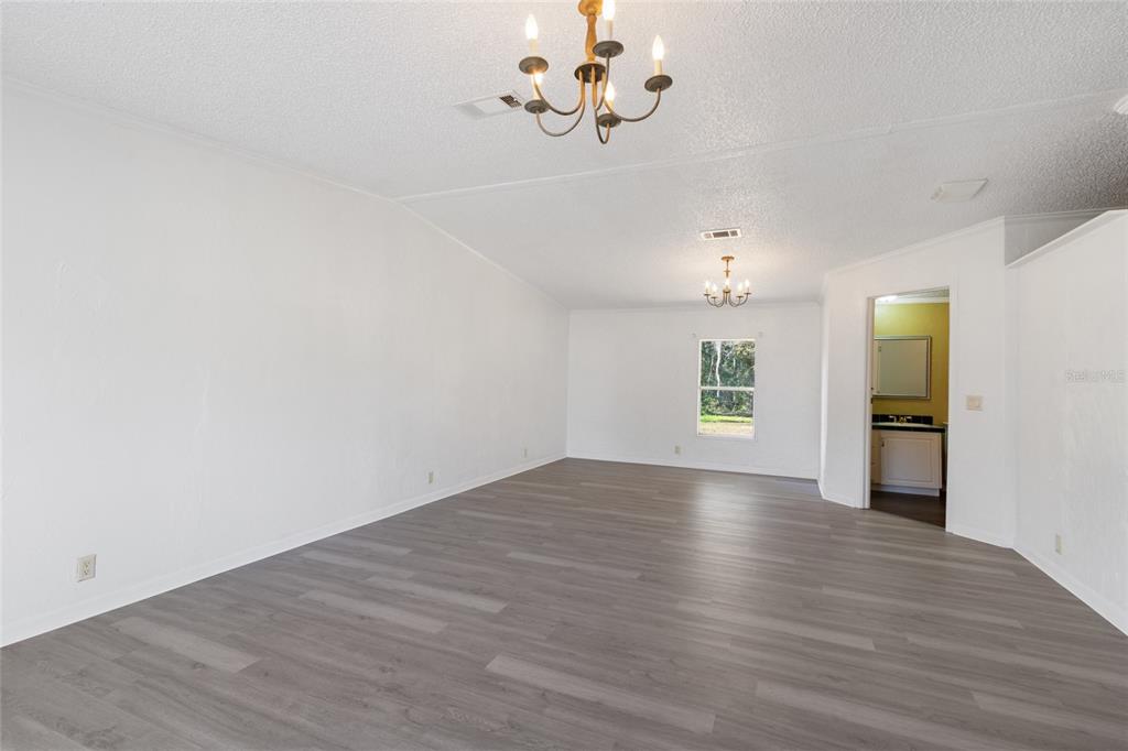 4912 Miley Road Plant City, FL 33565 - Photo 12 of 48 wooden floor in an empty room with a window