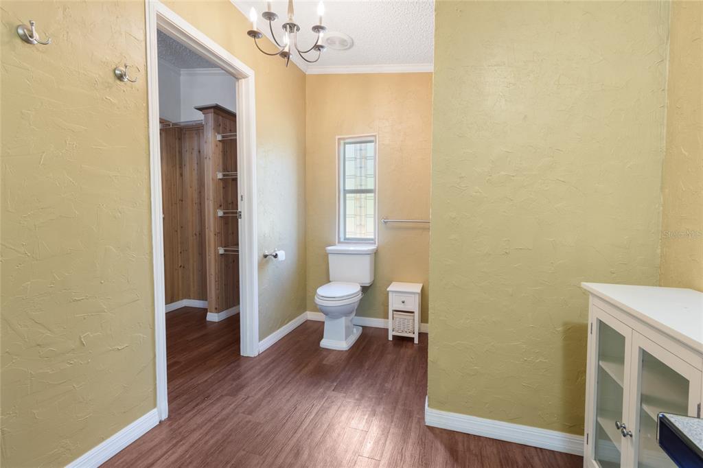 4912 Miley Road Plant City, FL 33565 - Photo 14 of 48 a bathroom with a toilet a sink and mirror