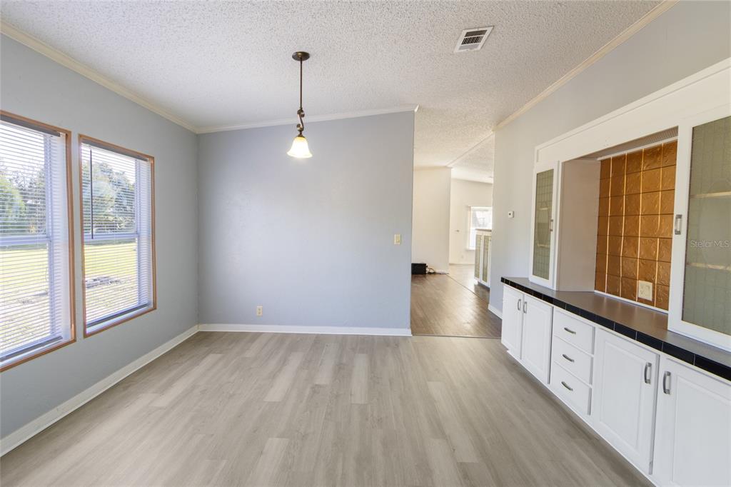 4912 Miley Road Plant City, FL 33565 - Photo 22 of 48 a view of an empty room with wooden floor and a window