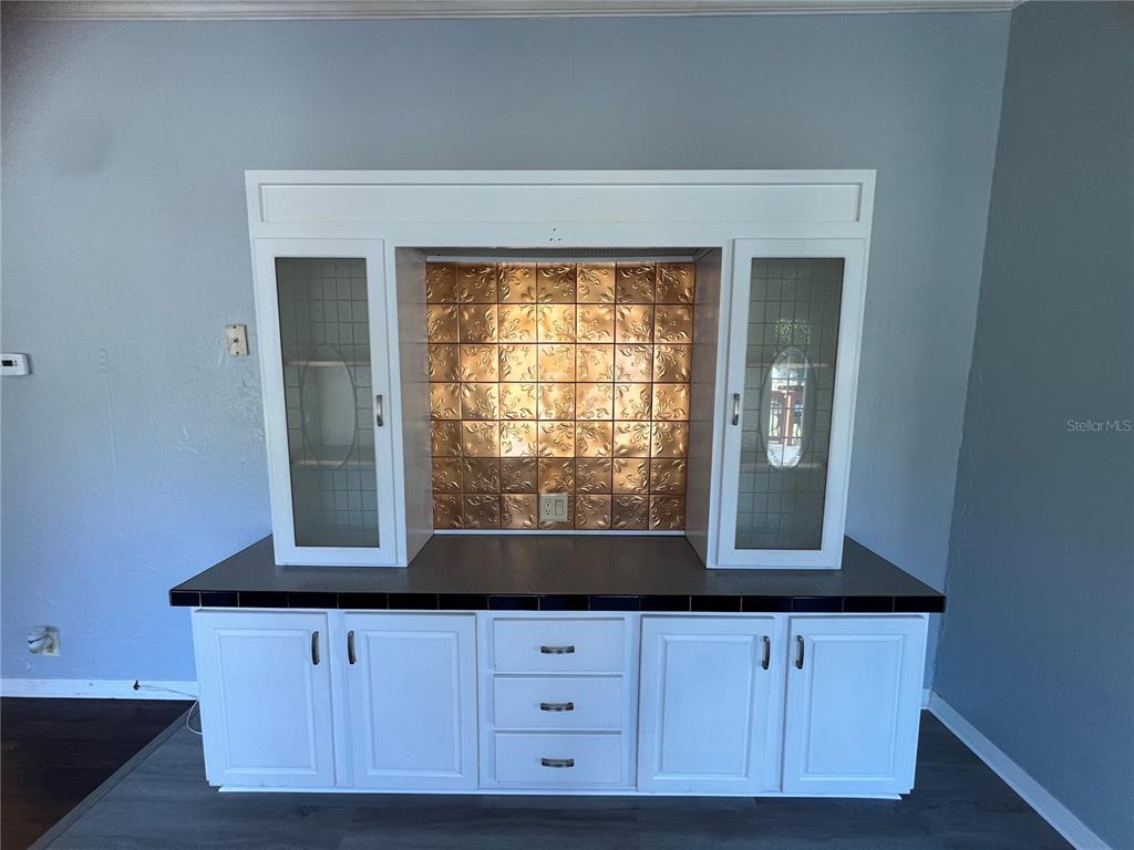 4912 Miley Road Plant City, FL 33565 - Photo 23 of 48 a kitchen with granite countertop white cabinets and a large window