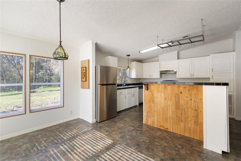 4912 Miley Road Plant City, FL 33565 - Photo 27 of 48 a kitchen with stainless steel appliances granite countertop a refrigerator and a sink