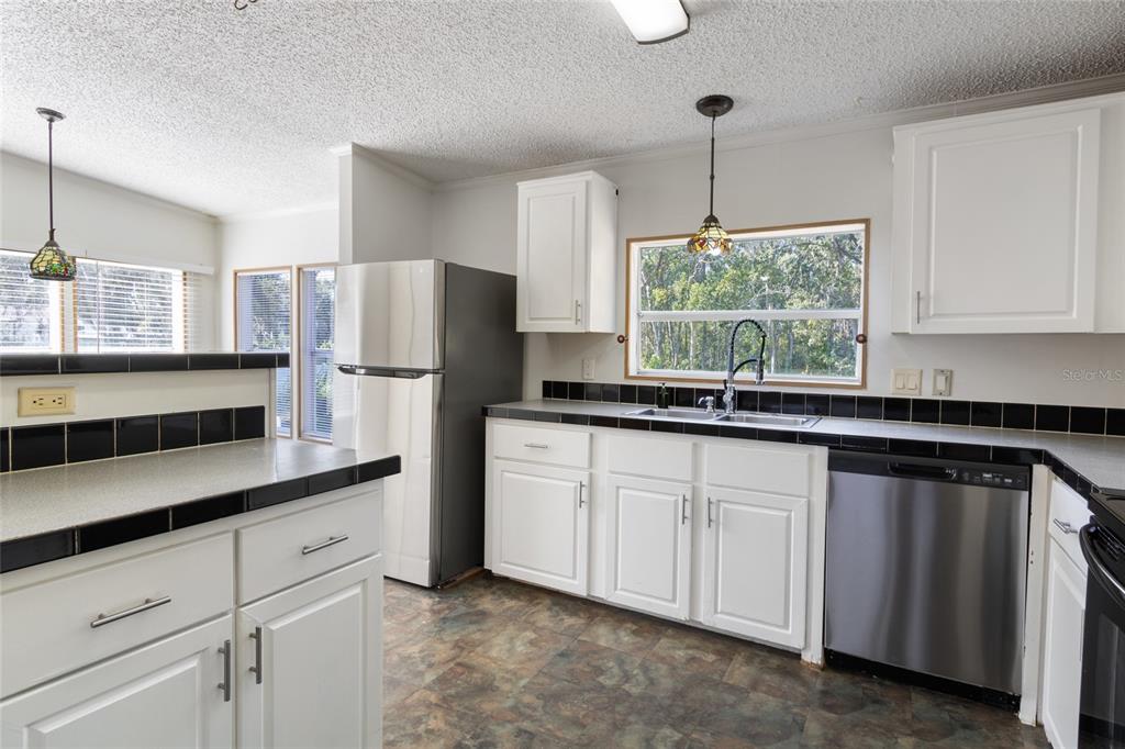 4912 Miley Road Plant City, FL 33565 - Photo 29 of 48 a kitchen with appliances cabinets and a counter top space