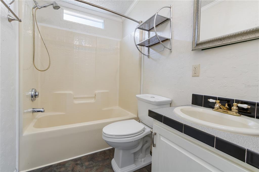 4912 Miley Road Plant City, FL 33565 - Photo 37 of 48 a bathroom with a sink a toilet and shower