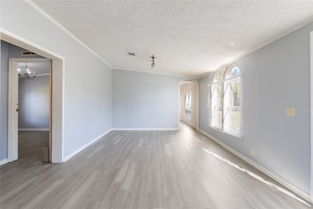 4912 Miley Road Plant City, FL 33565 - Photo 6 of 48 a view of an empty room with wooden floor and a window