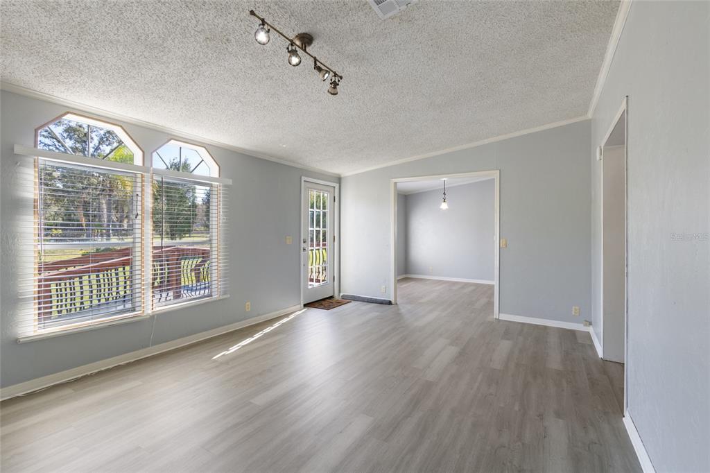 4912 Miley Road Plant City, FL 33565 - Photo 7 of 48 a view of an empty room with a window and wooden floor