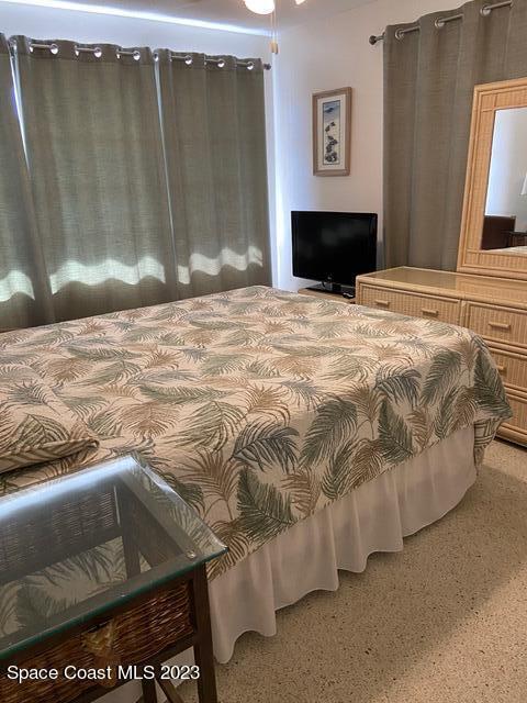 146 Bimini Road Cocoa Beach, FL 32931 - Photo 15 of 37 a bedroom with a bed and a mirror