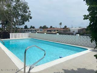 146 Bimini Road Cocoa Beach, FL 32931 - Photo 21 of 37 a view of a swimming pool with a yard